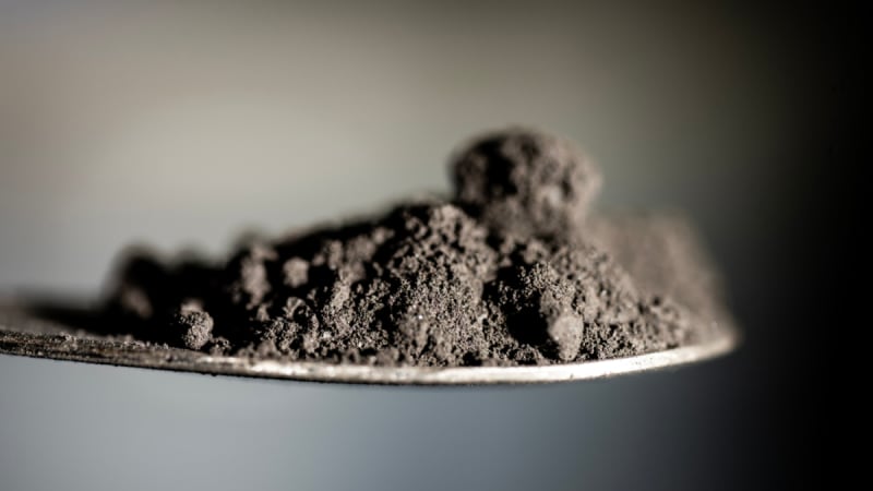 Close-up photograph of coal tailings showing fine rock particles and mineral deposits at research facility