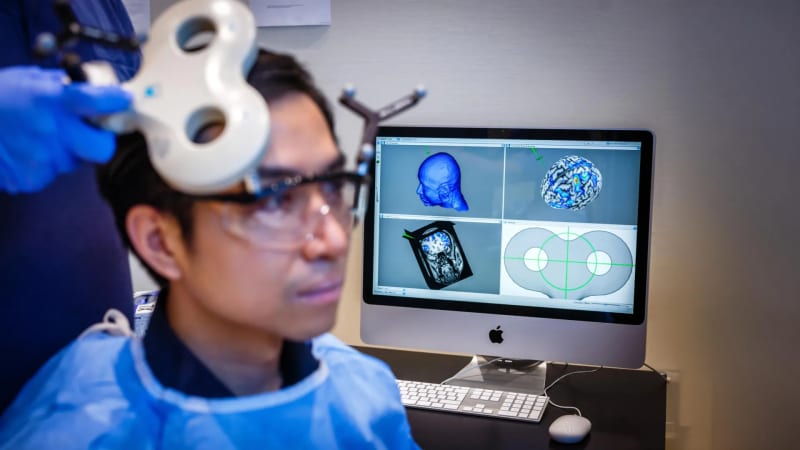 Research participant wearing brain stimulation device during laboratory experiment testing generosity