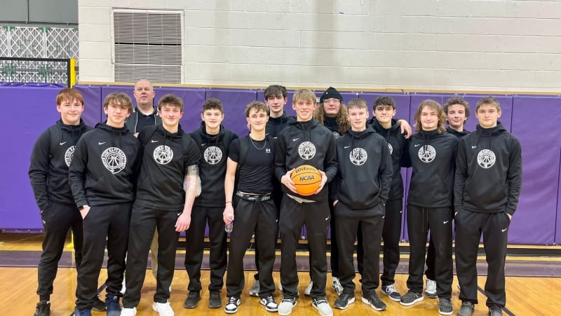 AC Corfield playing basketball in South Side High School uniform celebrating historic achievement