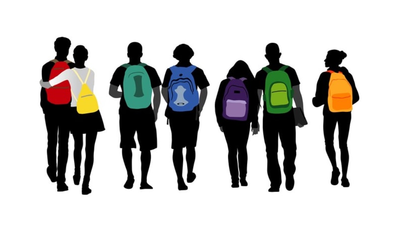 Diverse group of teenagers walking with colorful backpacks in silhouette representing youth mental health