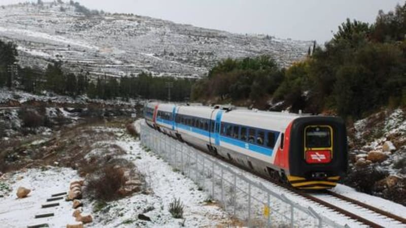 Modern Israeli railway train on tracks with digital overlay showing underground infrastructure mapping technology in action