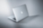 Apple laptop computer partly open.