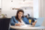 Lady in her kitchen reading over paper work