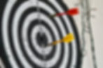 Dart board with red and yellow dart