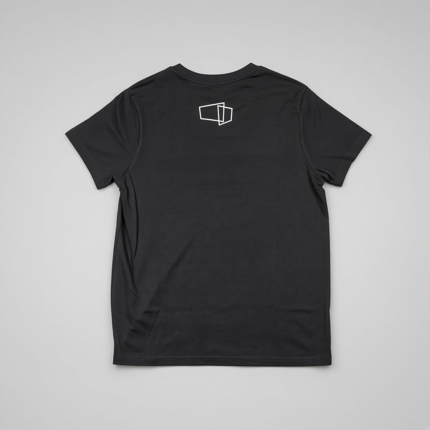 Back of the black fitted T-shirt, with a small white outline graphic below the collar.