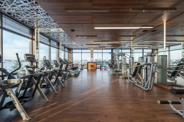 Hotel gym with large windows overlooking a natural landscape