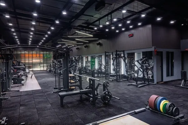 Gym interior with clear circulation and negative space between equipment