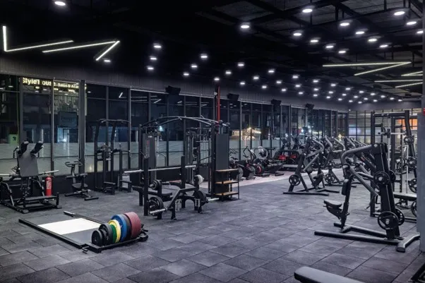 Gym interior with layered architectural lighting