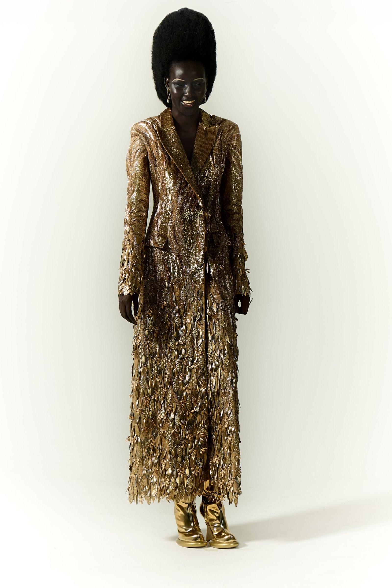 Dress by RAHUL MISHRA, boots by FRANCESCA BELLAVITA, earrings by ALEXIS BITTAR, ring by NINO SEPO