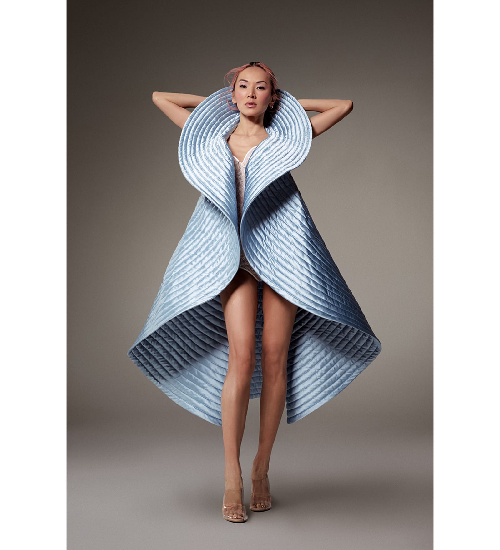 Look 22, Tina Leung. "Disc" coat in quilted glacier-blue duchesse satin. Worn over a lace body-corset. (Photos: Courtesy of Alexis Mabille)