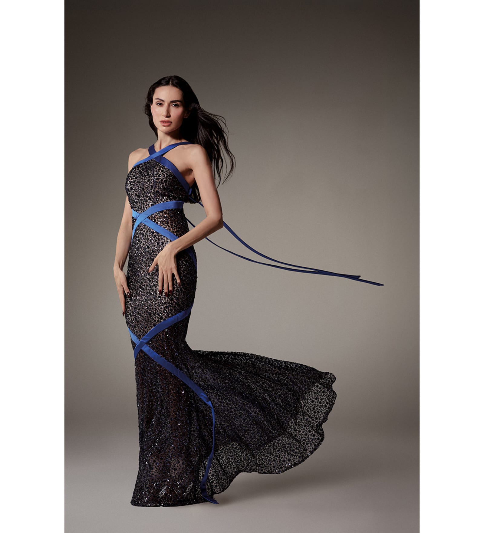 Look 30, Diala Makki. Long sheath dress in midnight-blue embroidered tulle
wrapped in royal blue satin ribbons.