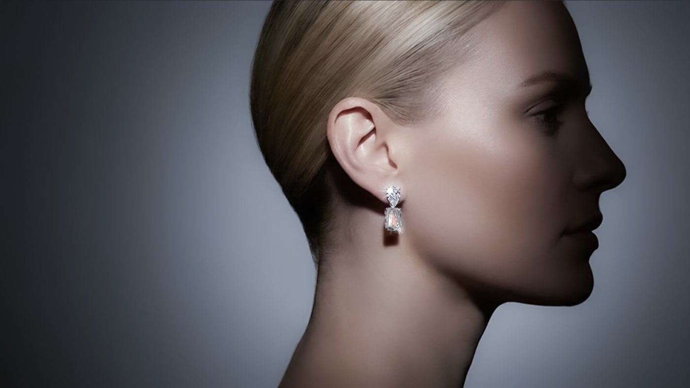 Fine oval diamond earrings shown on model demonstrating the elongated silhouette and flattering proportion at the face