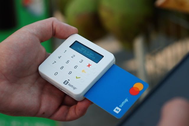 man holding card reader with card inside