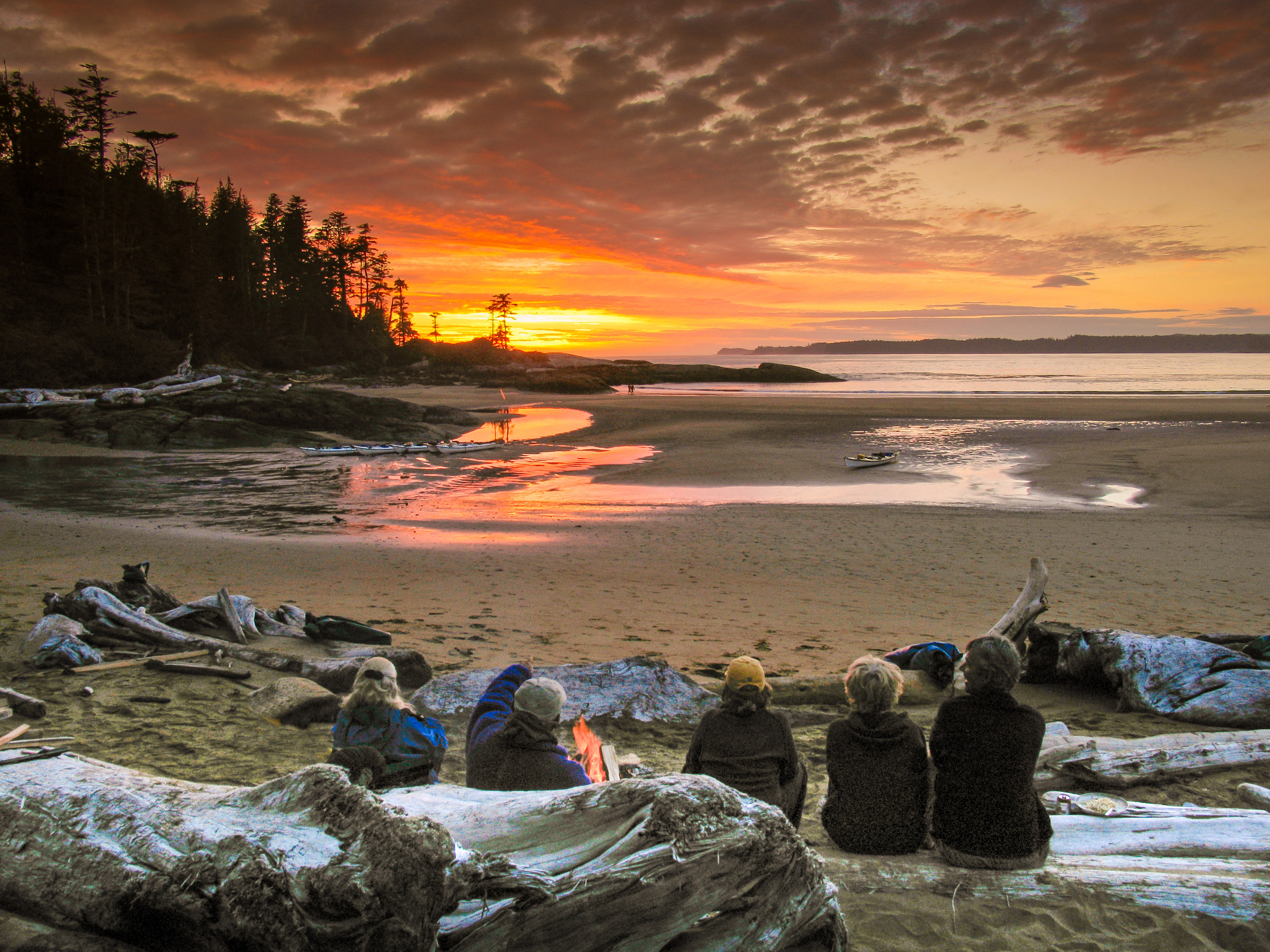 Kayaking group on the BC coast at sunset