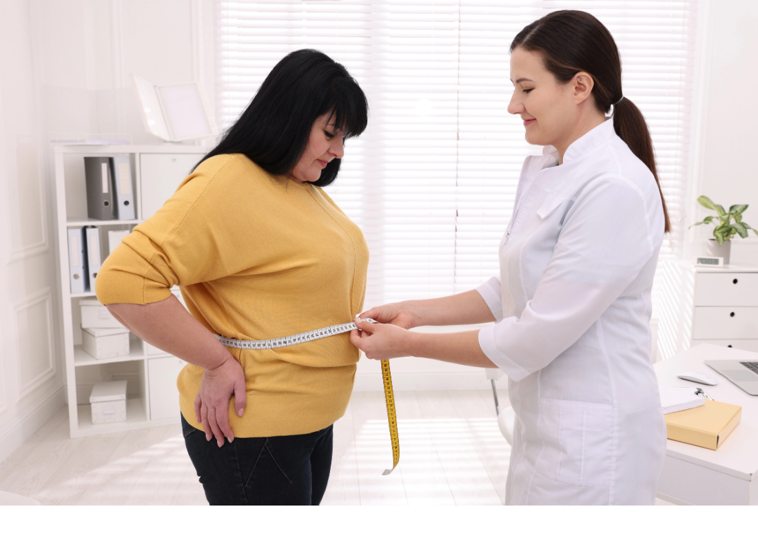 Women's health coach measuring a patient's waist during a consultation