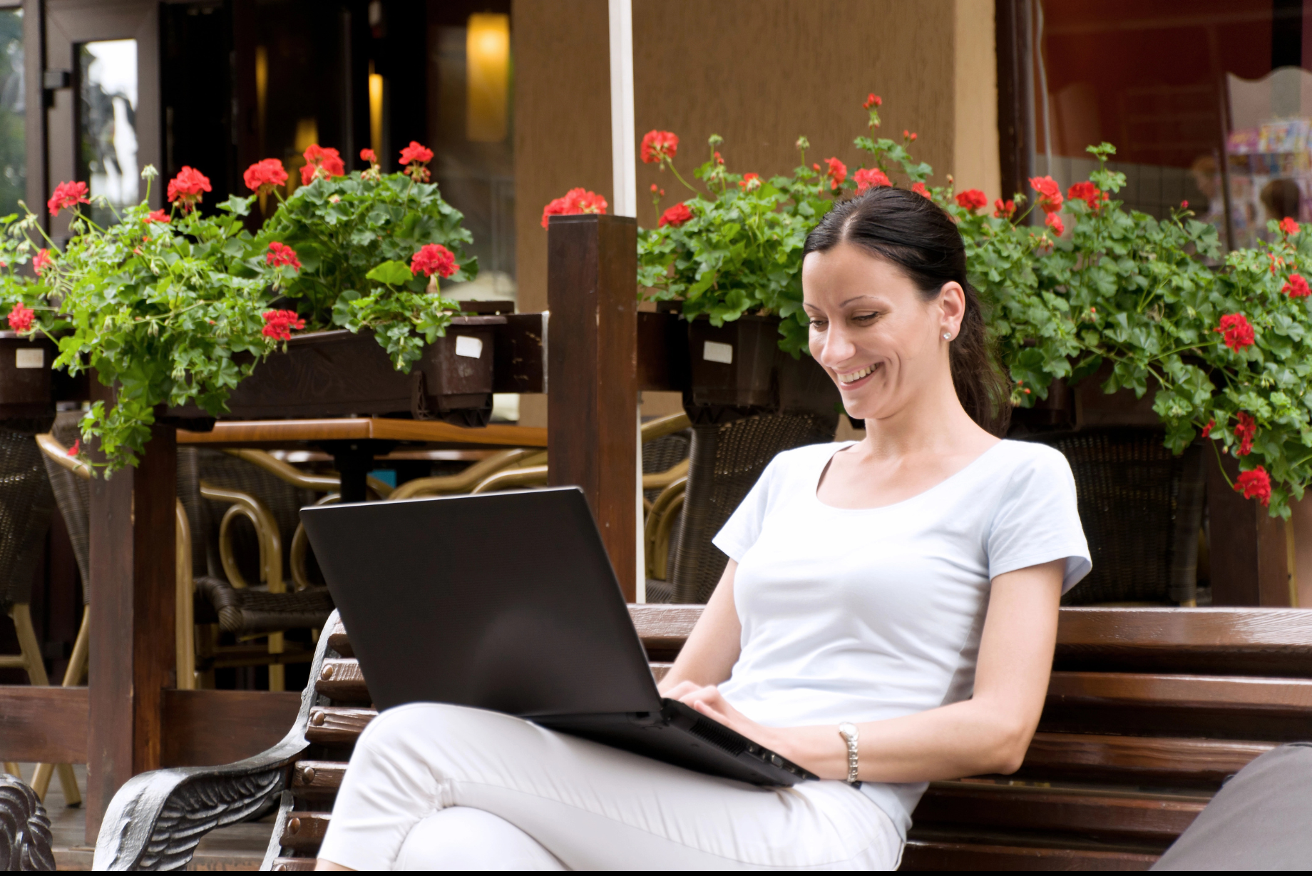 Woman sitting with laptop — focused and ready to follow up