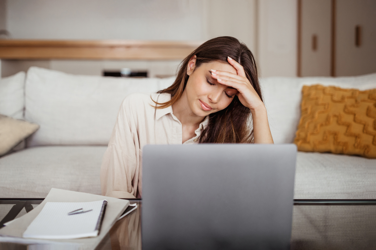 Woman looking frustrated at laptop