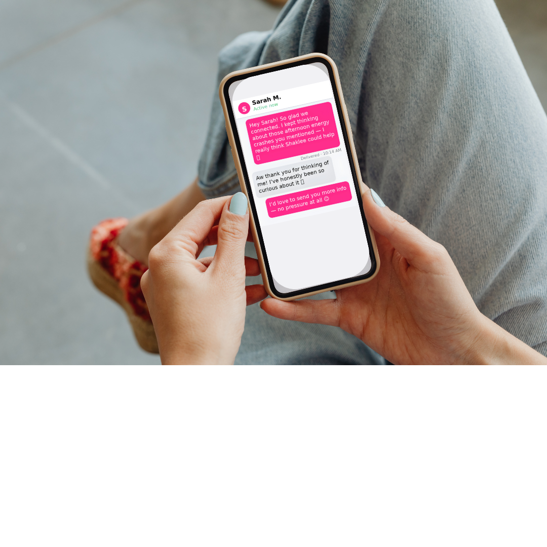 Woman holding a smartphone showing a follow-up message conversation