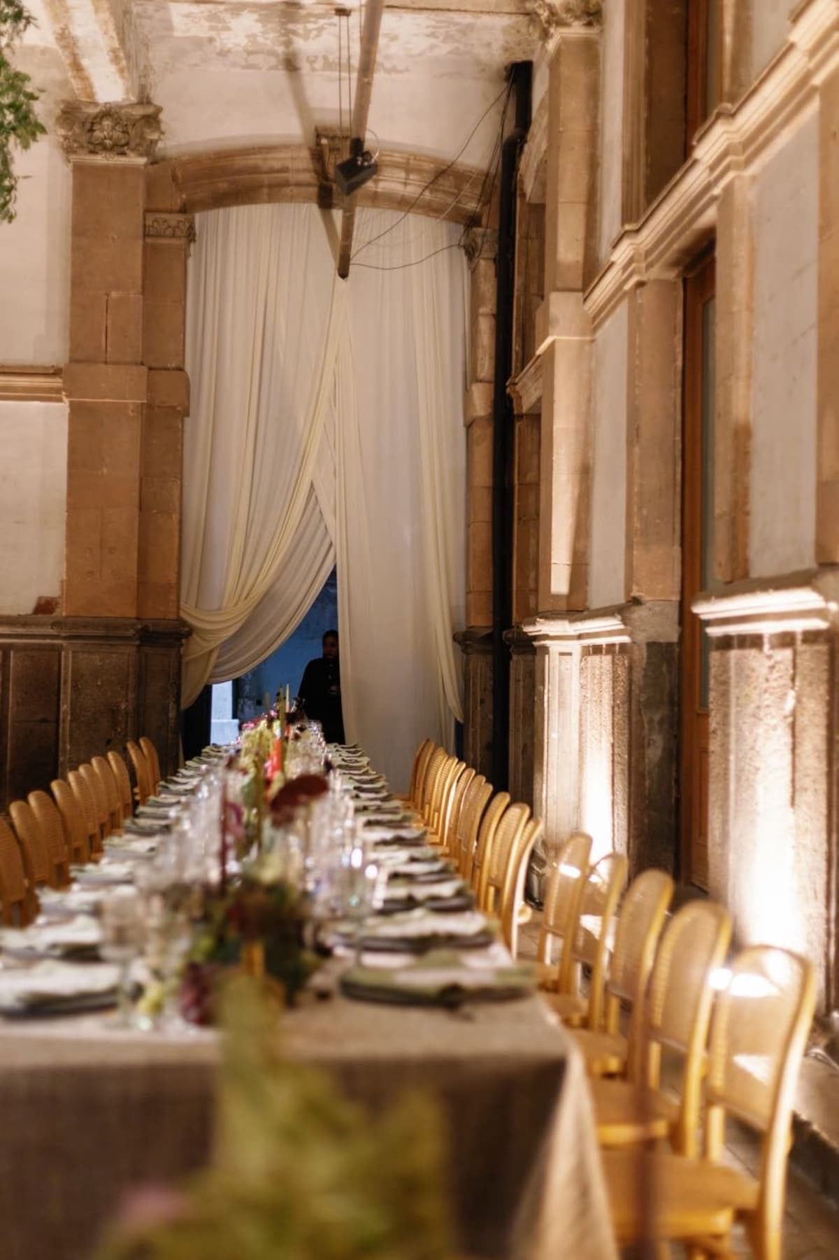 Atmospheric elegant venue details featuring custom stage lighting for a luxury wedding reception