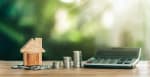 modellino di casa con soldi spiccioli e calcolatrice modellino di casa con soldi spiccioli e calcolatrice
