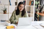 Ragazza al computer seduta alla scrivania