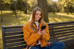 Ragazza sorride al cellulare Ragazza sorride al cellulare
