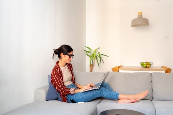 ragazza sul divano naviga al pc
