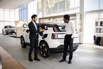 Uomo che sceglie suv elettrico in concessionaria