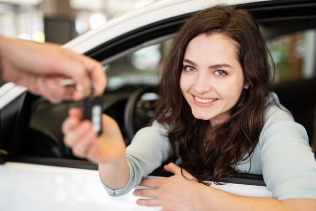 giovane ragazza prende le chiavi dell'auto giovane ragazza prende le chiavi dell'auto