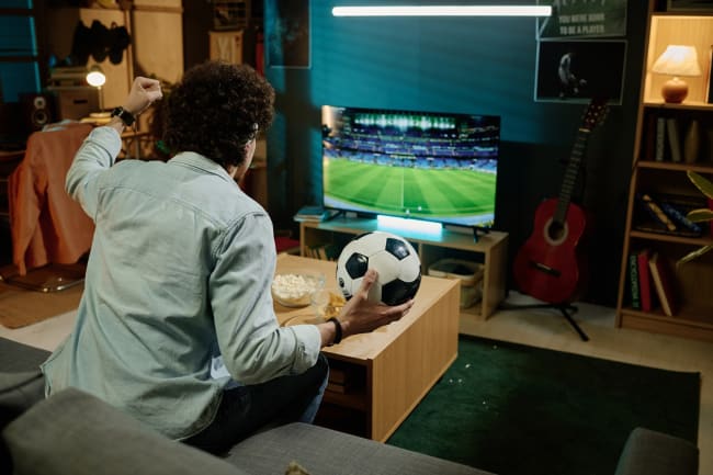 Ragazzo guarda calcio alla tv