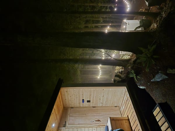 Finnish sauna at dusk with warm interior lighting