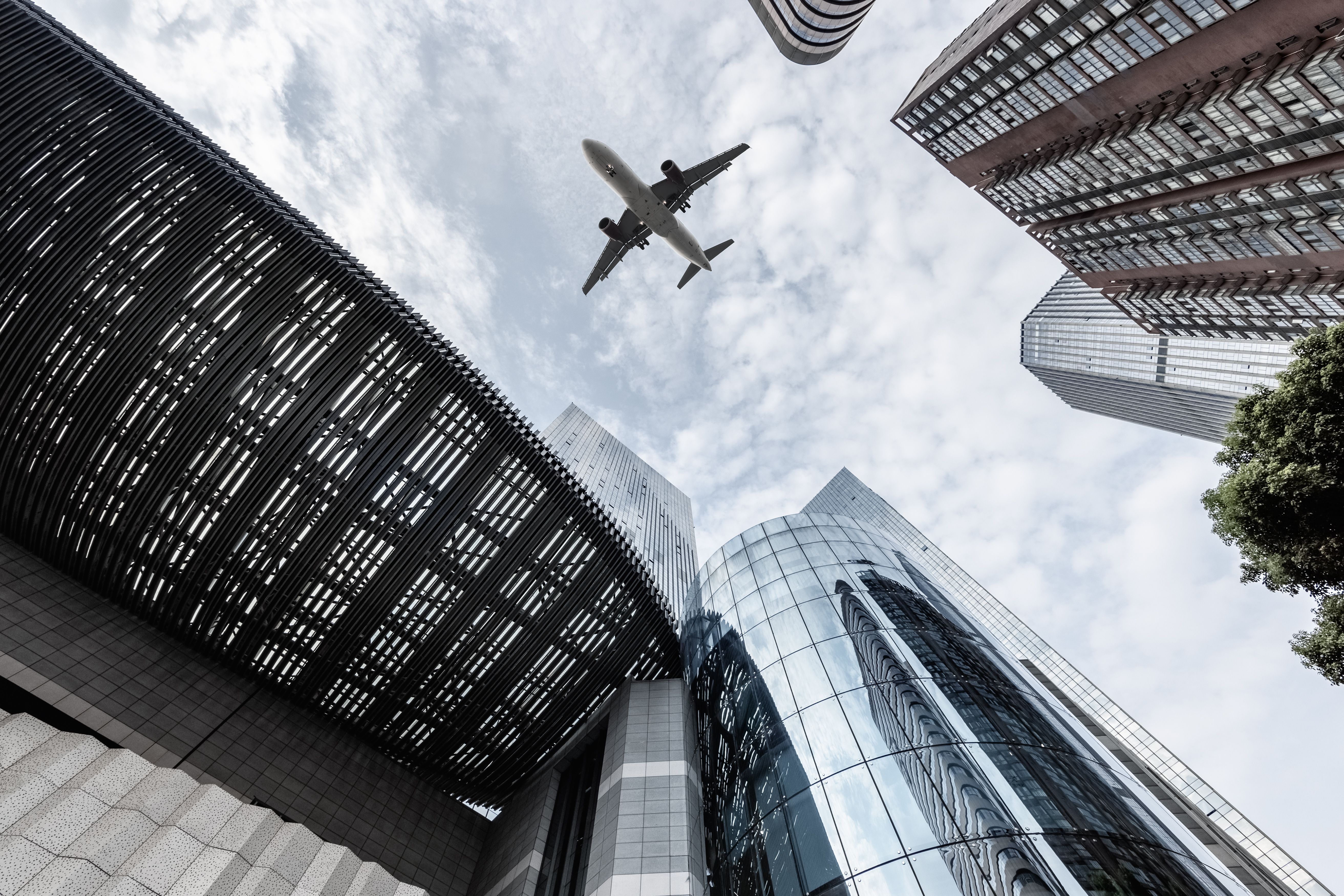 upward-view-of-airplane-and-modern-building-2023-11-27-05-21-58-utc.jpg