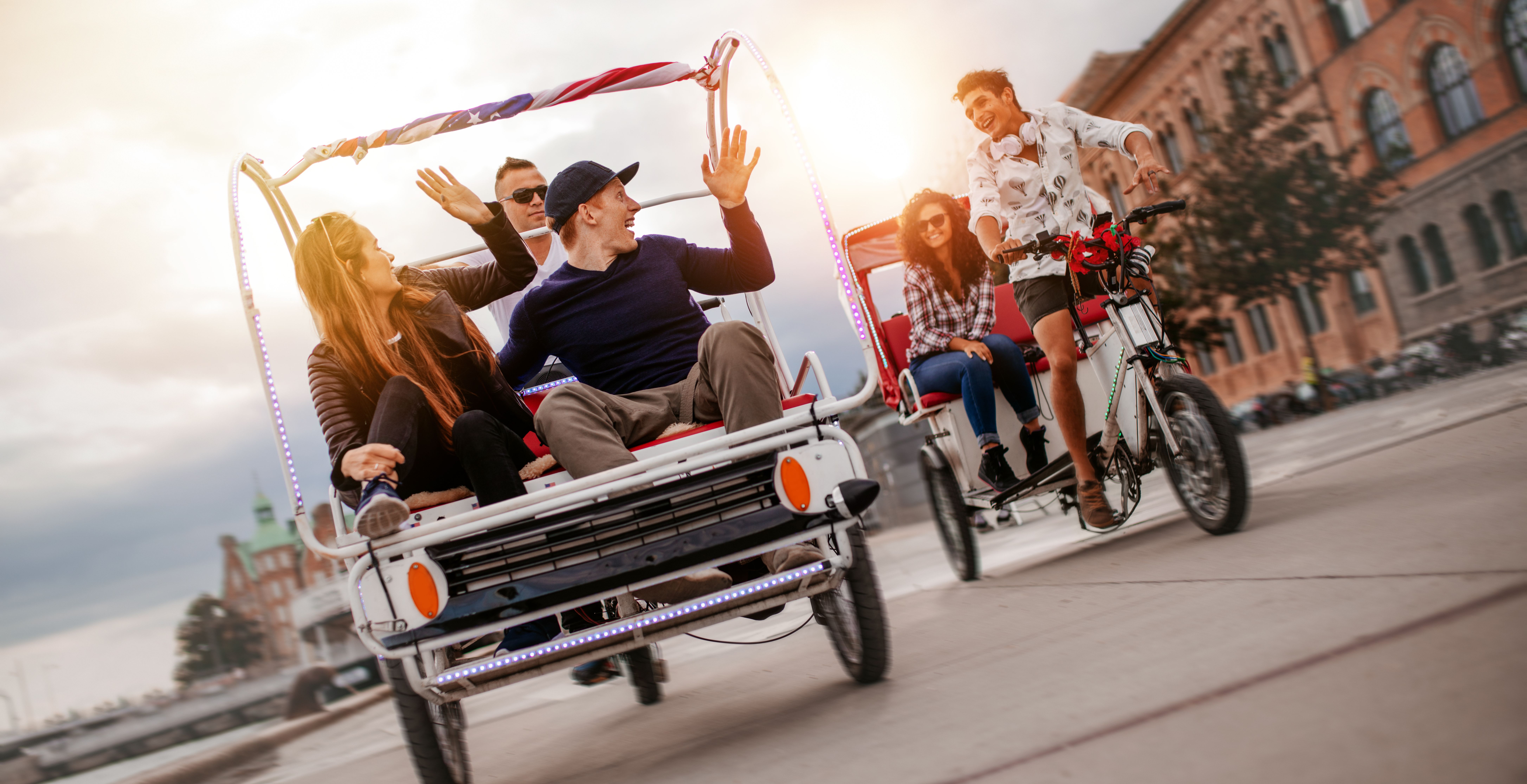 group-of-friends-having-fun-with-two-tricycles-on-2023-11-27-05-04-50-utc.jpg