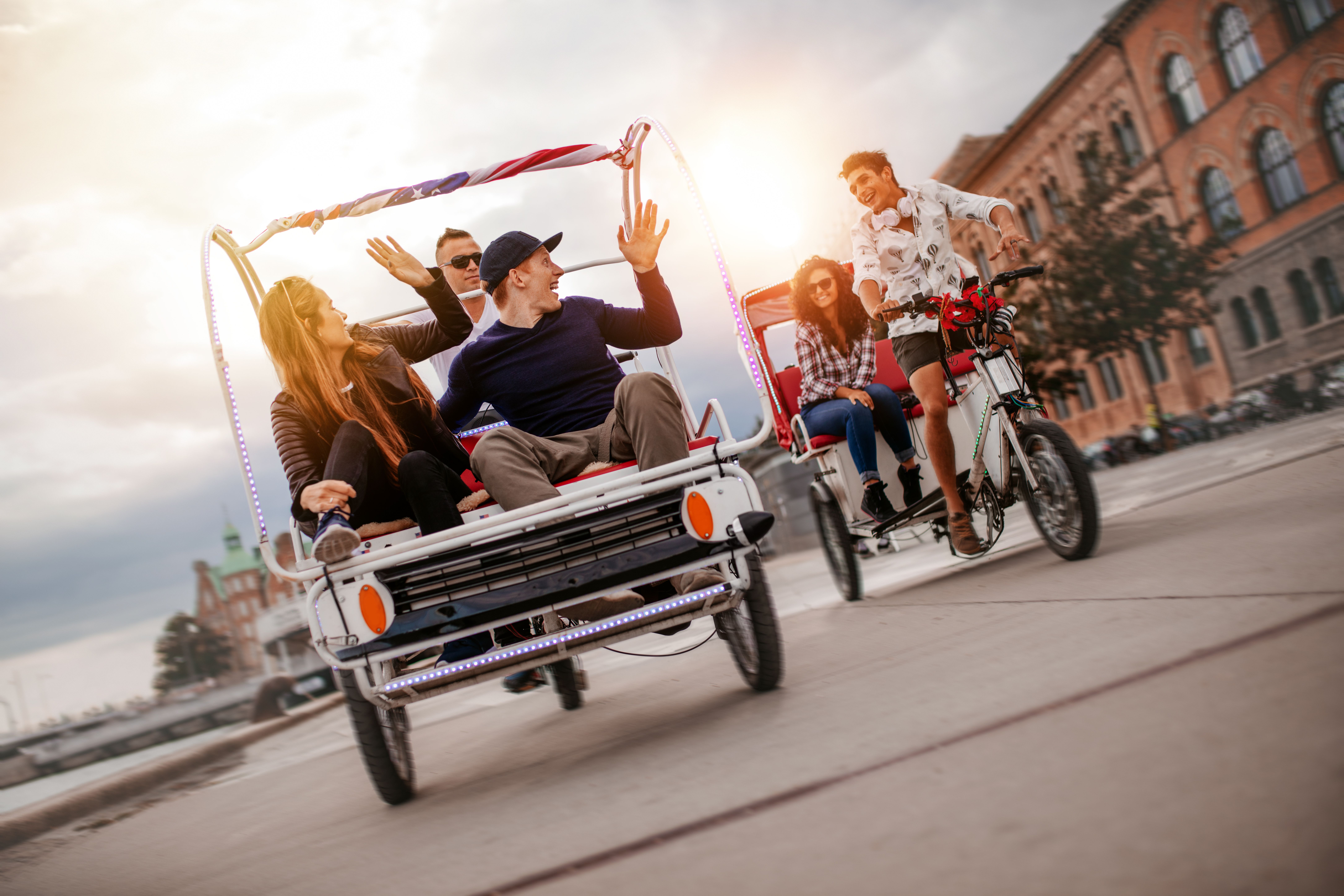 group-of-friends-having-fun-with-two-tricycles-on-2024-09-13-10-29-41-utc.jpg