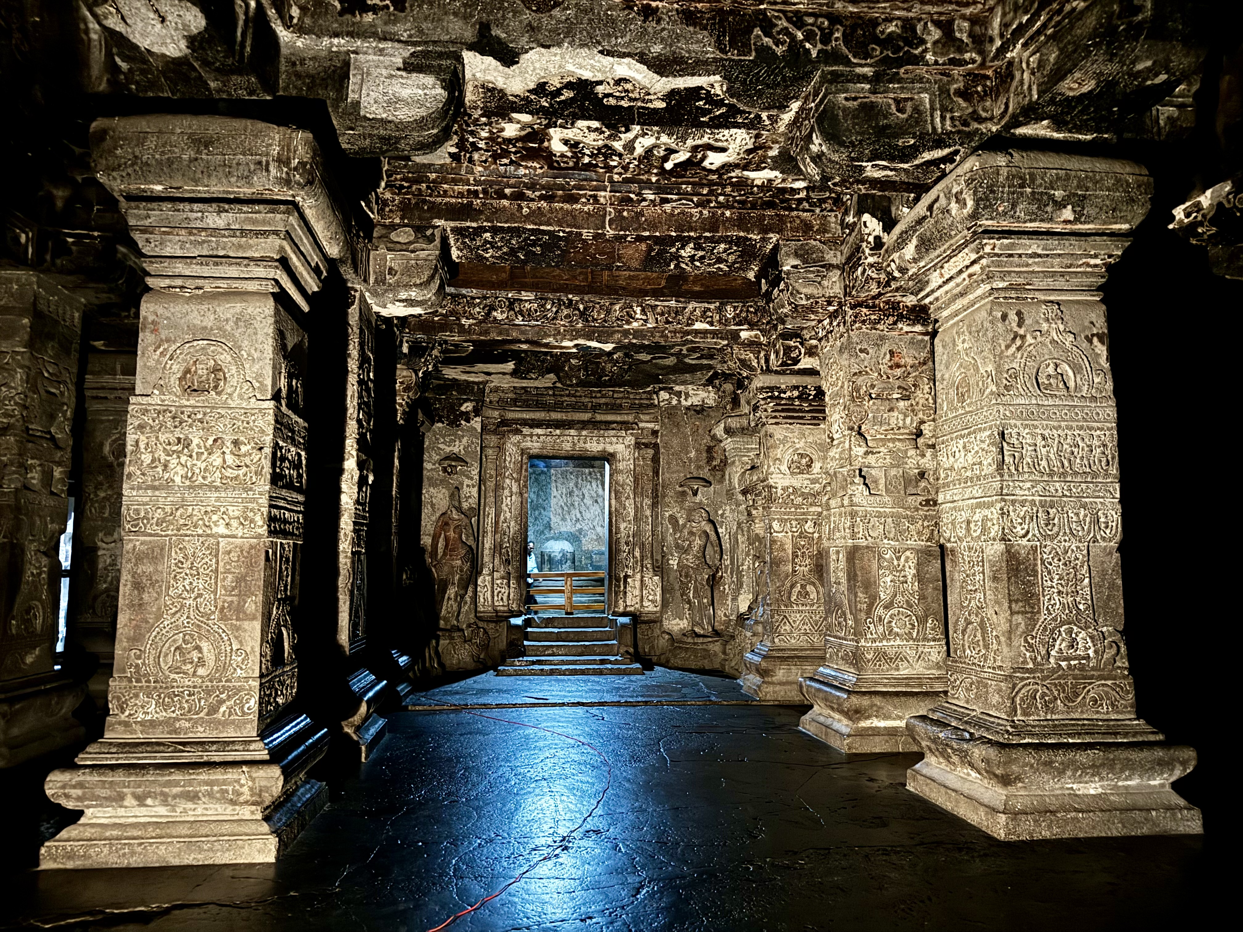 Hindu-style pillars leading up to a Shivalinga inside the temple