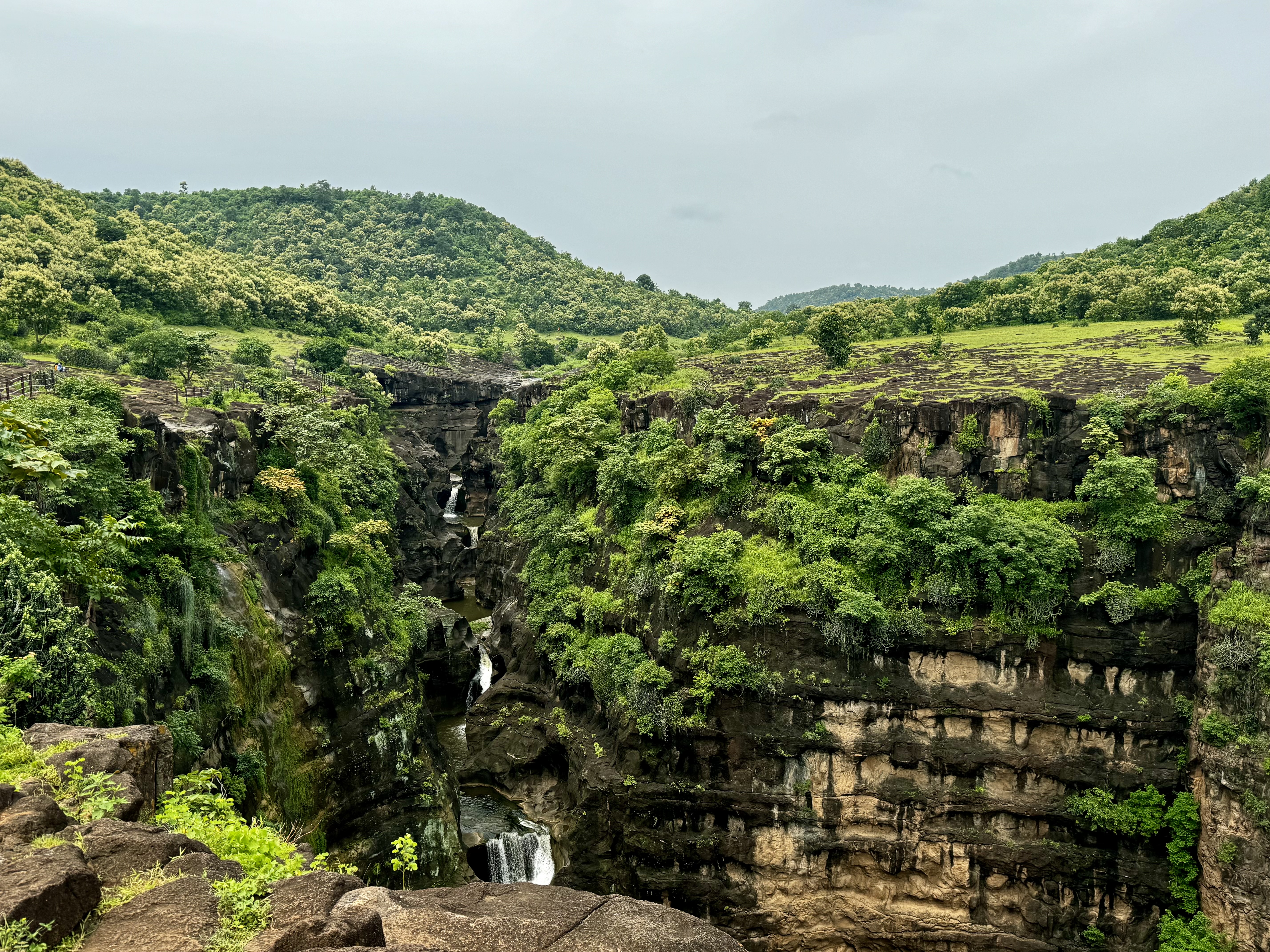 A waterfall running down the hills into a valley