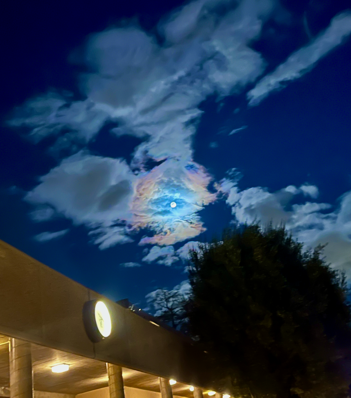 The moon at night surrounded by clouds