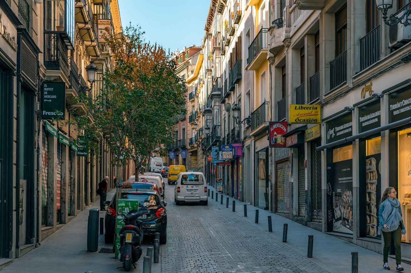 Street with shops and cars in Madrid