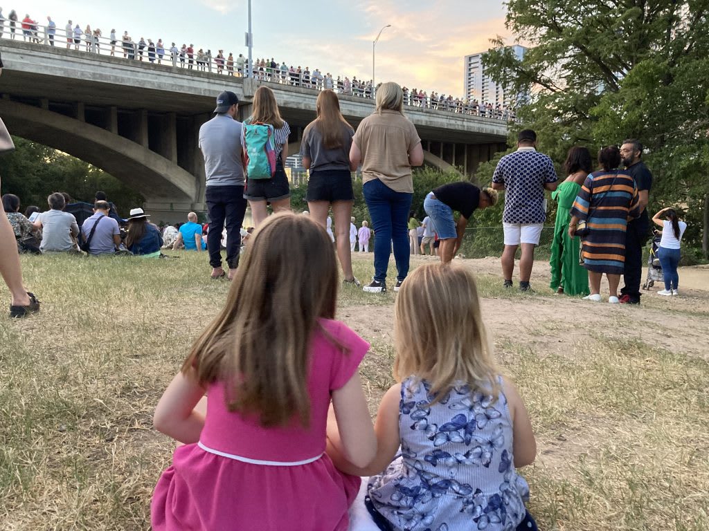 Two girls watch bats in Austin