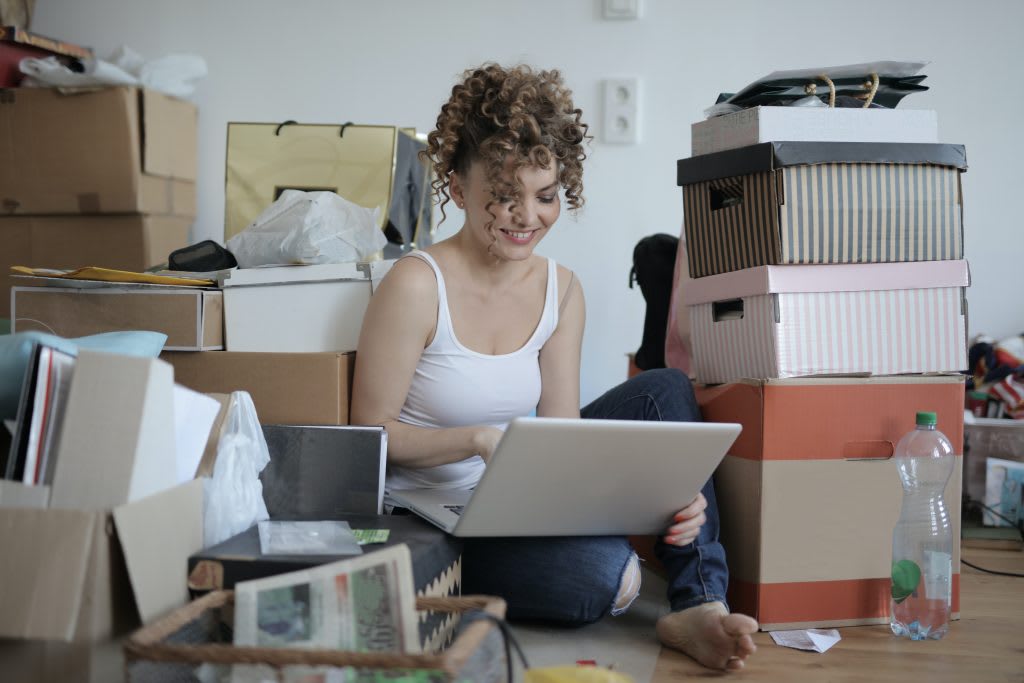 Woman sitting in messy room