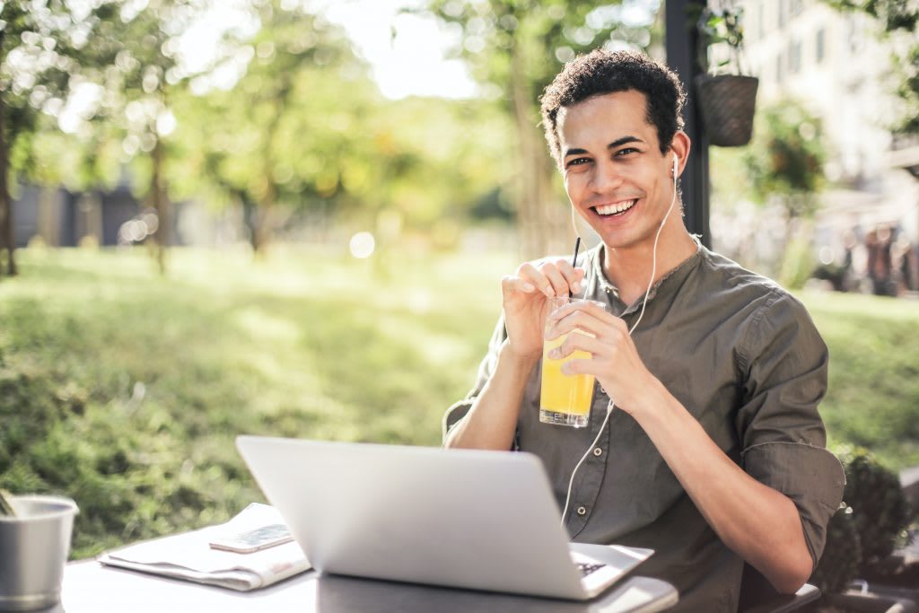 Man sipping drink while working outside