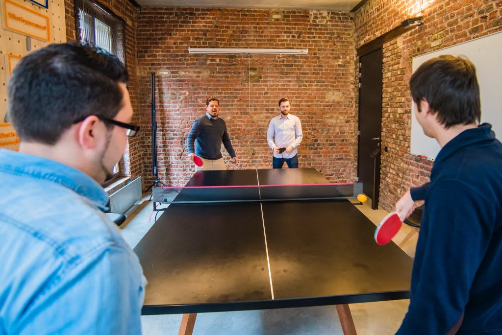 Group of men playing table tennis