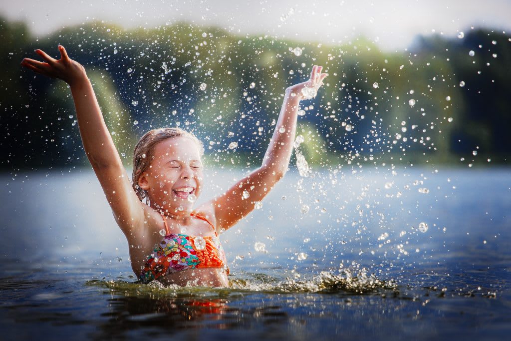 Girl splashing in lake