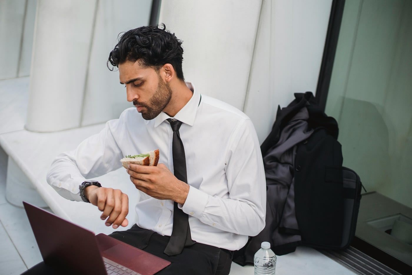 Man looking at watch during lunch