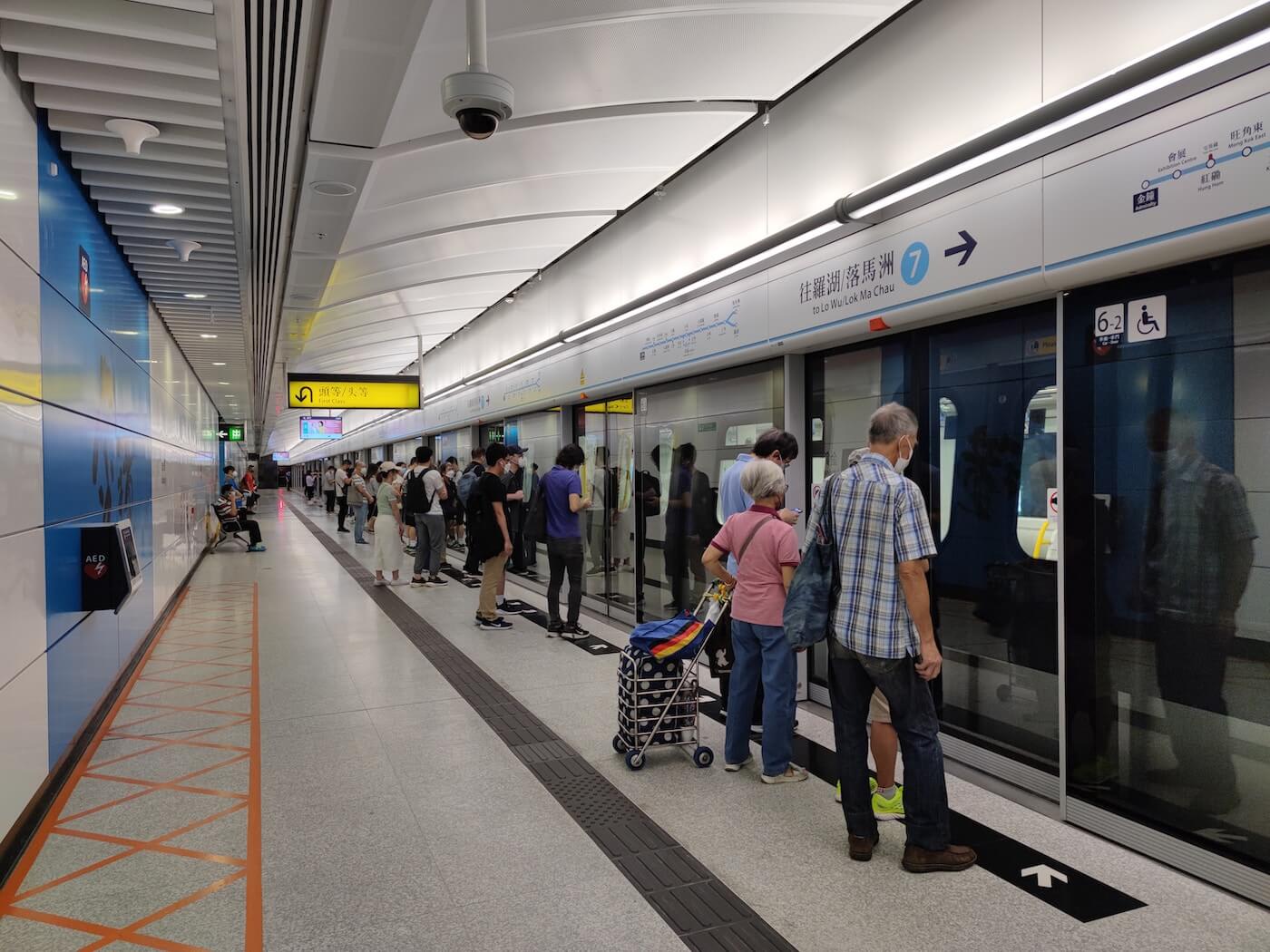 Passengers waiting to board on the train in MRT station in Hong Kong