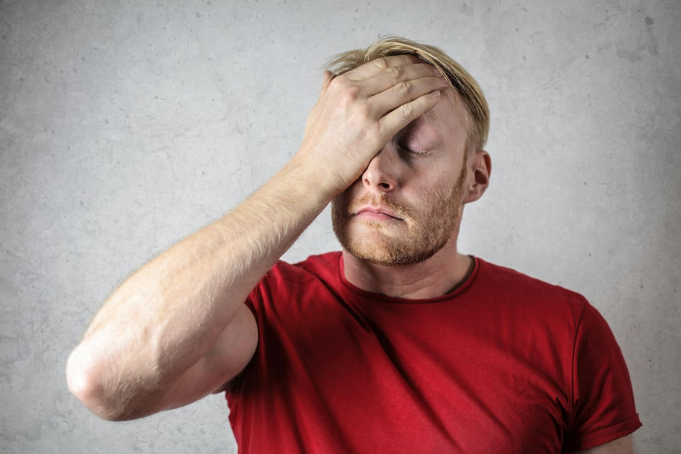 Confused man with a hand to his head