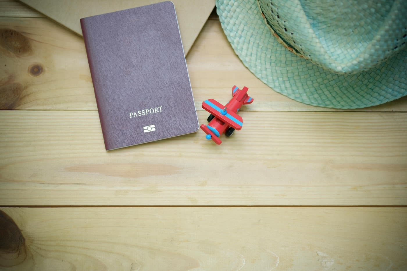 Passport on a table with toy plane