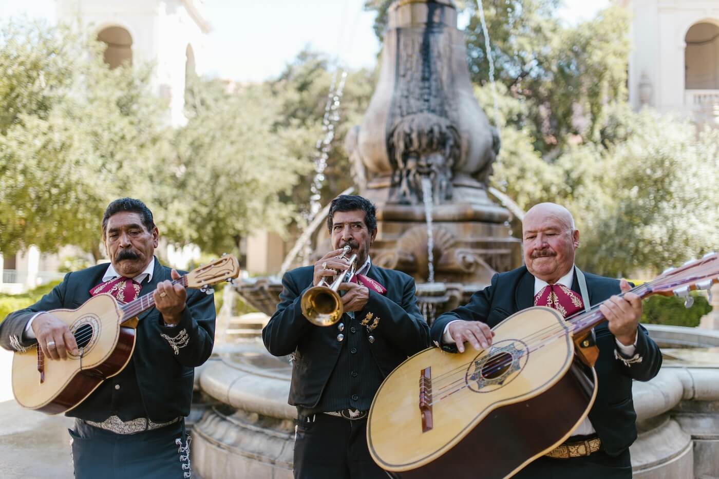 Three men playing in a mariachi band