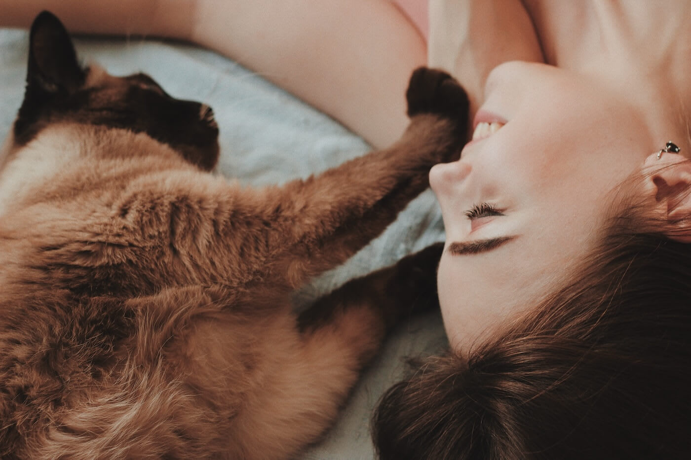 Woman and her cat on a bed