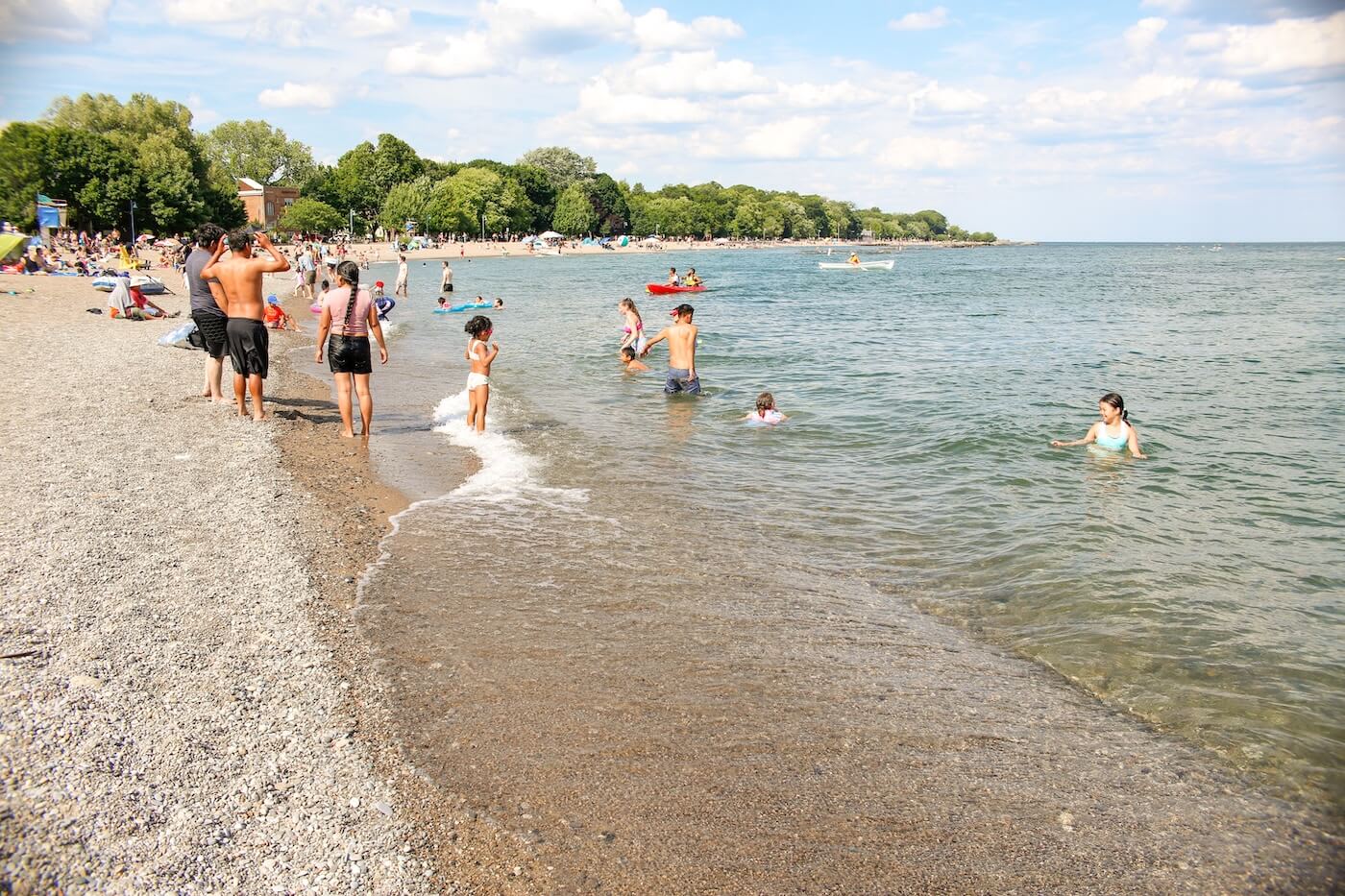 People swimming and playing at a beach in Toronto